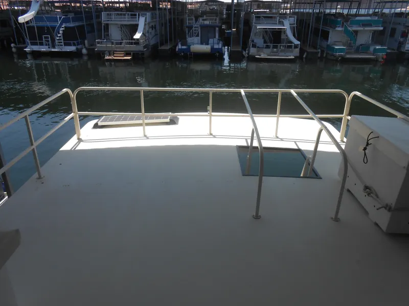 Slide: The Image of 1984 Boatel Hercules deck with railing, overlooking marina with docked boats. - 23