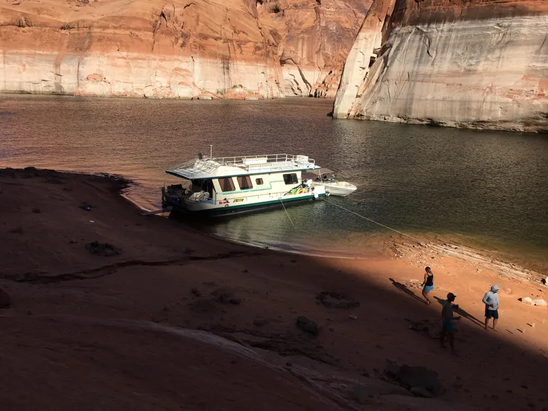 Slide: The Image of Houseboat "Boatel Hercules" 1984 docked on a scenic desert lake shore with red rock cliffs. - 4