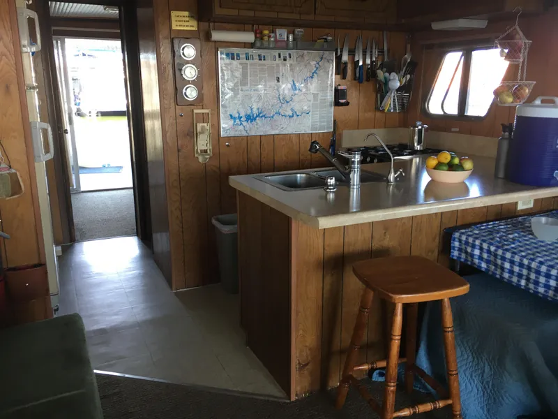 Slide: The Image of 1984 Boatel Hercules interior with wooden kitchen, map, and dining area. - 5
