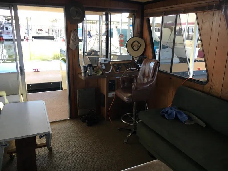 Slide: The Image of Interior of a 1984 Boatel Hercules houseboat with seating and helm. - 7