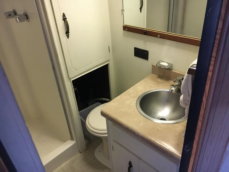 Slide: The Image of Compact bathroom in 1984 Boatel Hercules, featuring sink, toilet, and shower. - 8