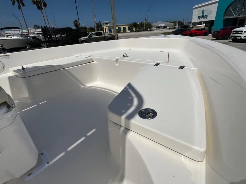 Slide: The Image of 2021 Cobia 21 Bay boat interior with seating and storage compartments. - 10
