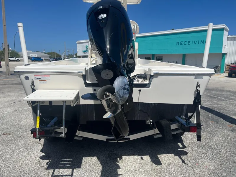 Slide: The Image of 2021 Cobia 21 Bay boat rear view with outboard motor in a parking lot. - 4