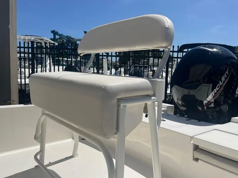 Slide: The Image of 2021 Cobia 21 Bay boat with white seating and Mercury outboard motor. - 7