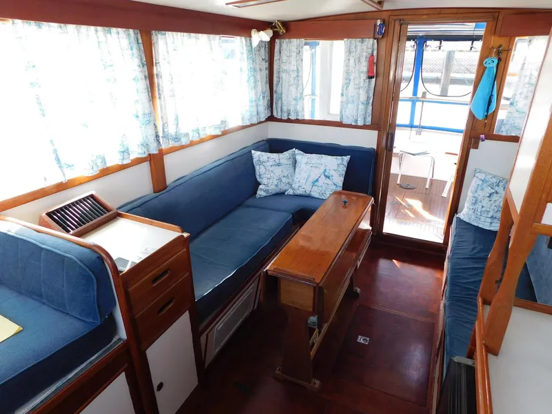 Slide: The Image of Interior of a 1979 Grand Banks 32 Sedan with blue seating and wooden accents. - 10