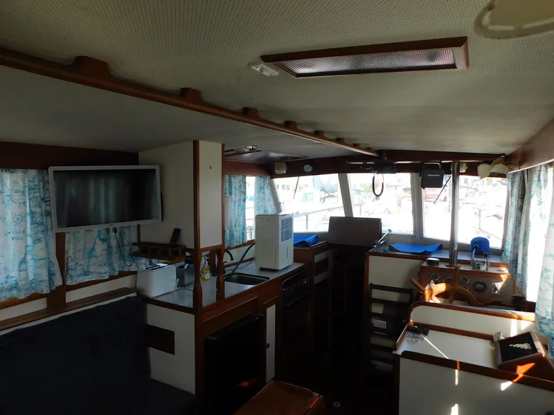 Slide: The Image of Interior of a 1979 Grand Banks 32 Sedan boat with kitchen and seating area. - 17