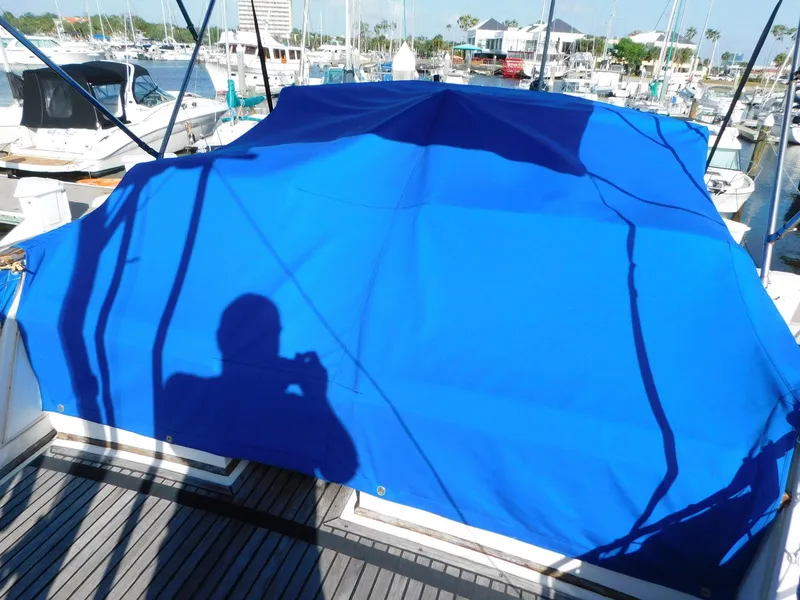 Slide: The Image of 1979 Grand Banks 32 Sedan with blue cover in marina setting. - 18