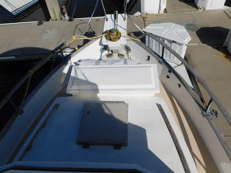 Slide: The Image of 1979 Grand Banks 32 Sedan boat deck with docked marina view. - 21