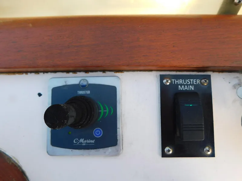 Slide: The Image of 1979 Grand Banks 32 Sedan thruster controls with joystick and switch panel. - 23