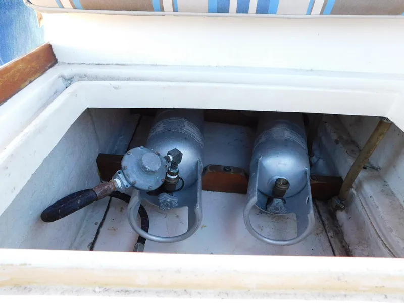 Slide: The Image of Two propane tanks in a storage compartment on a 1979 Grand Banks 32 Sedan boat. - 25