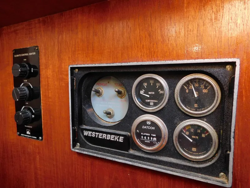 Slide: The Image of 1979 Grand Banks 32 Sedan engine control panel with Westerbeke gauges on wooden dashboard. - 3