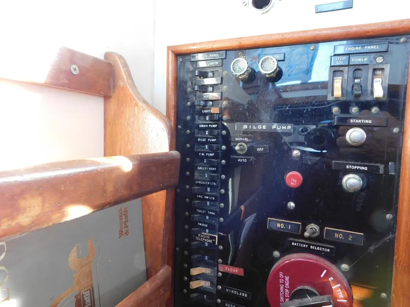 Slide: The Image of 1979 Grand Banks 32 Sedan control panel with switches and dials. - 4