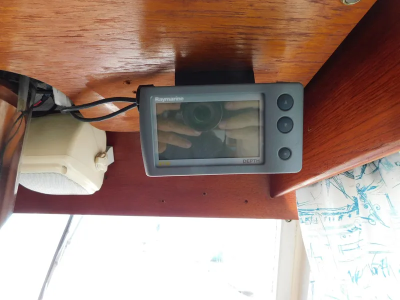 Slide: The Image of 1979 Grand Banks 32 Sedan interior with Raymarine display and speaker. - 6