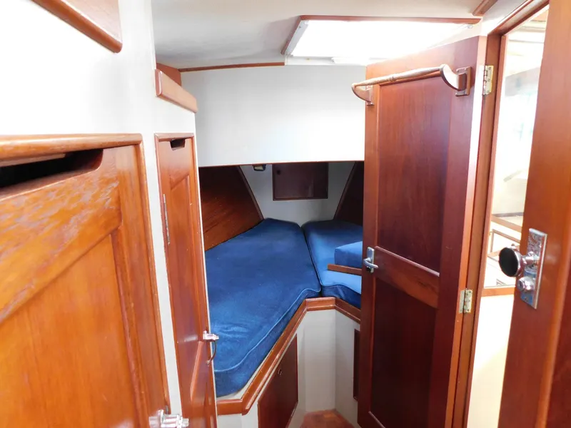 Slide: The Image of 1979 Grand Banks 32 Sedan cabin interior with blue cushions and wooden finishes. - 9