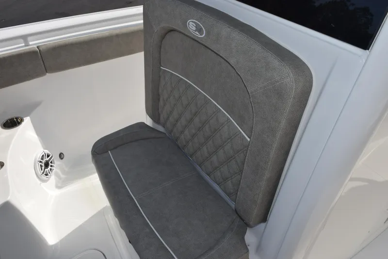 Slide: The Image of 2025 Sea Hunt Ultra 255 SE boat seat with gray upholstery and white accents. - 12