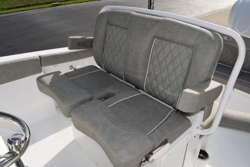 Slide: The Image of 2025 Sea Hunt Ultra 255 SE boat with gray cushioned seating and diamond stitching. - 13