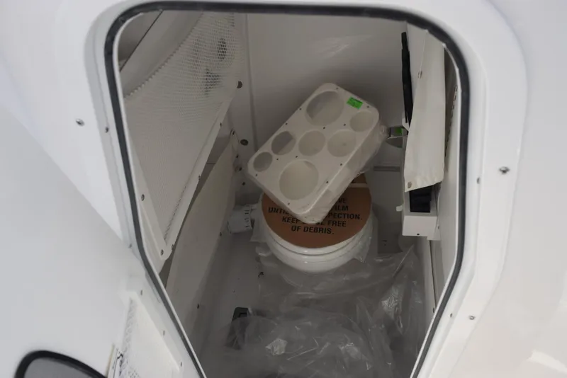 Slide: The Image of Storage compartment inside 2025 Sea Hunt Ultra 255 SE boat, featuring various items. - 14