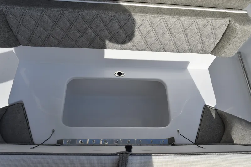 Slide: The Image of 2025 Sea Hunt Ultra 255 SE boat interior with cushioned seating and storage area. - 16