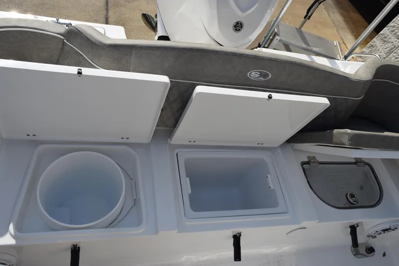Slide: The Image of 2025 Sea Hunt Ultra 255 SE boat storage compartments and seating area. - 19