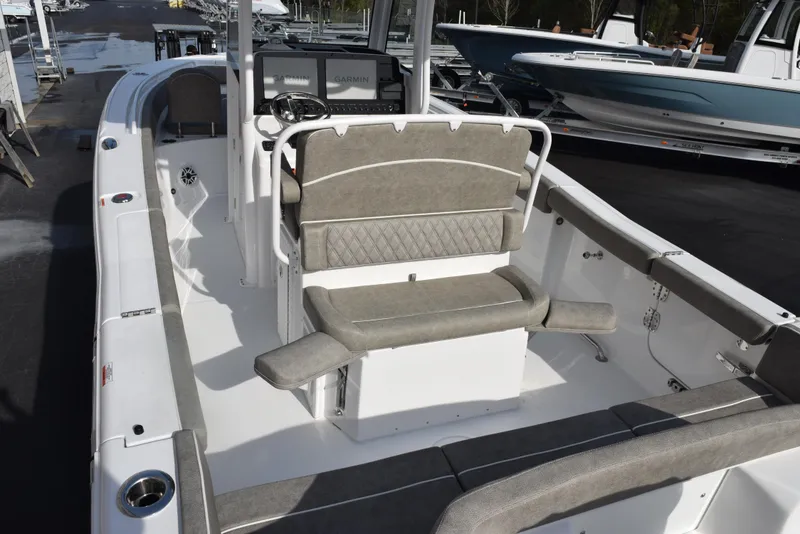 Slide: The Image of 2025 Sea Hunt Ultra 255 SE boat interior with seating and console, docked outdoors. - 6