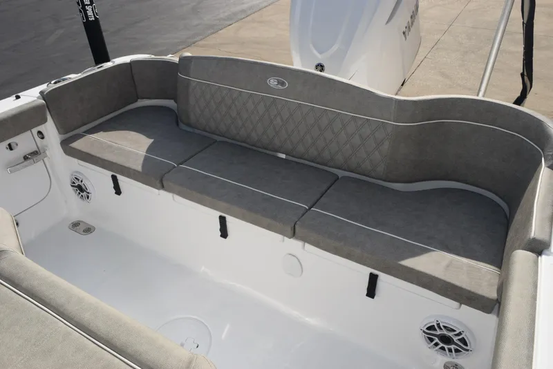 Slide: The Image of 2025 Sea Hunt Ultra 255 SE boat with gray cushioned seating and built-in speakers. - 8