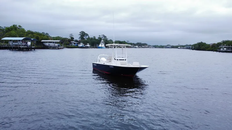 The Image of 2022 Boston Whaler 210 Montauk boat on a calm river with overcast skies. - 0