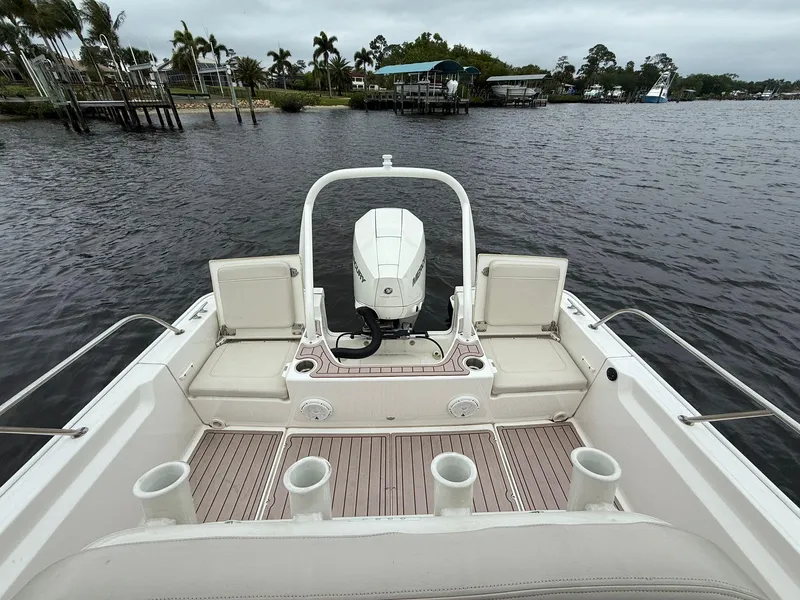 Slide: The Image of 2022 Boston Whaler 210 Montauk boat on water, featuring spacious deck and seating. - 10