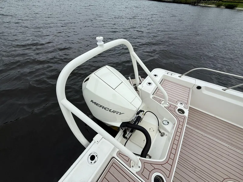Slide: The Image of 2022 Boston Whaler 210 Montauk with Mercury outboard motor on a calm lake. - 11