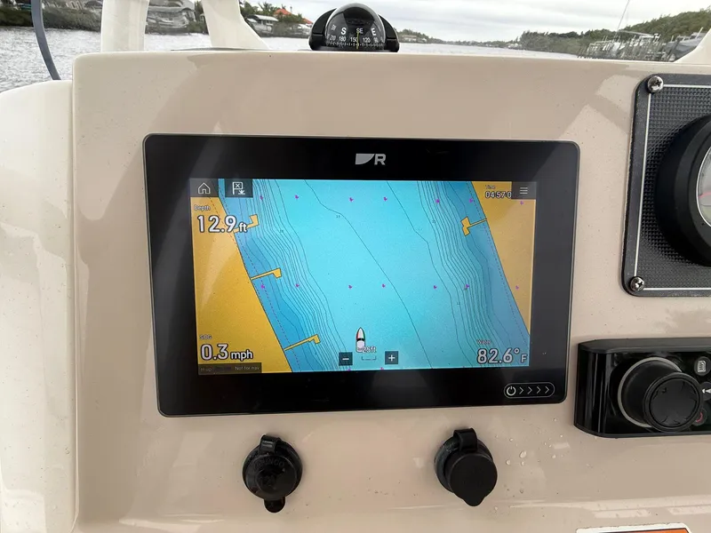 Slide: The Image of 2022 Boston Whaler 210 Montauk navigation display showing nautical map and speed data. - 15