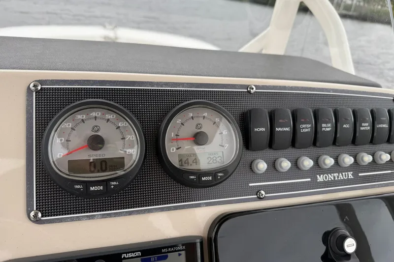 Slide: The Image of Control panel of 2022 Boston Whaler 210 Montauk boat with gauges and switches. - 19