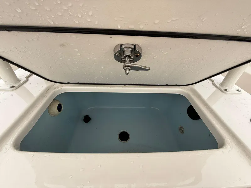 Slide: The Image of Open storage compartment on a 2022 Boston Whaler 210 Montauk boat. - 21