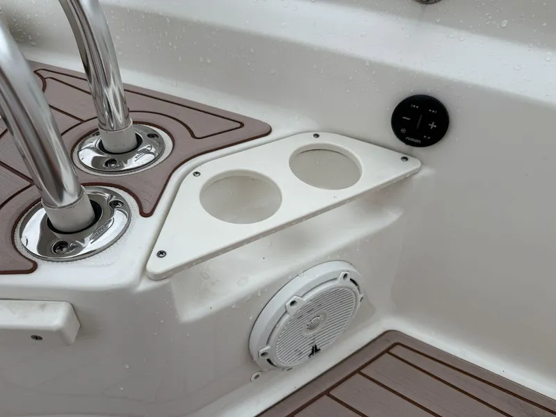 Slide: The Image of 2022 Boston Whaler 210 Montauk boat interior with cup holders and speaker. - 22