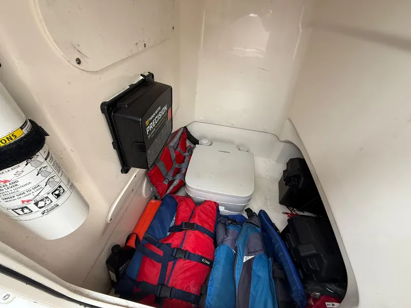 Slide: The Image of Interior of 2022 Boston Whaler 210 Montauk with life jackets and portable toilet. - 23