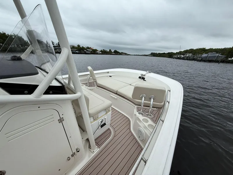 Slide: The Image of 2022 Boston Whaler 210 Montauk boat on a calm river under cloudy skies. - 4