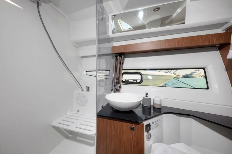 Slide: The Image of Modern bathroom interior of 2025 Jeanneau NC1095 Coupe yacht with sleek fixtures and window view. - 16