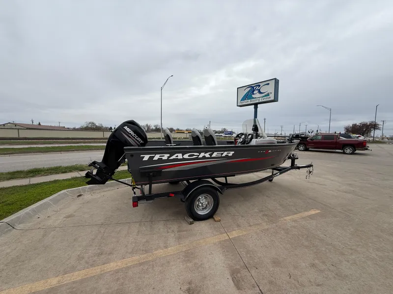 Slide: The Image of 2017 Tracker Pro Guide V-16 SC boat on trailer in parking lot. - 2