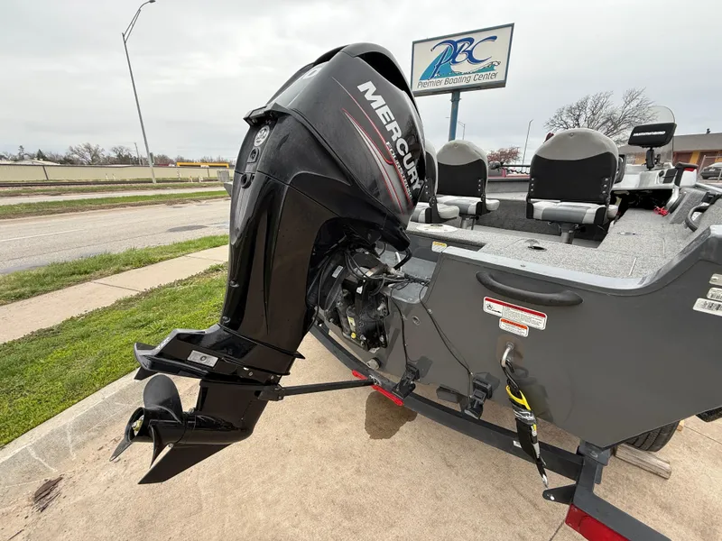 Slide: The Image of 2017 Tracker Pro Guide V-16 SC boat with Mercury outboard motor, parked on a trailer. - 4