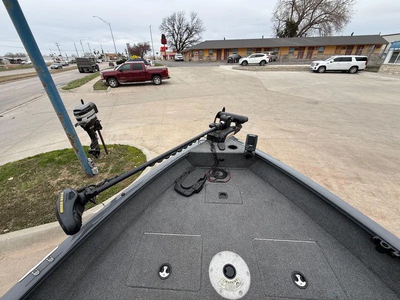 Slide: The Image of 2017 Tracker Pro Guide V-16 SC boat with trolling motor in parking lot. - 7