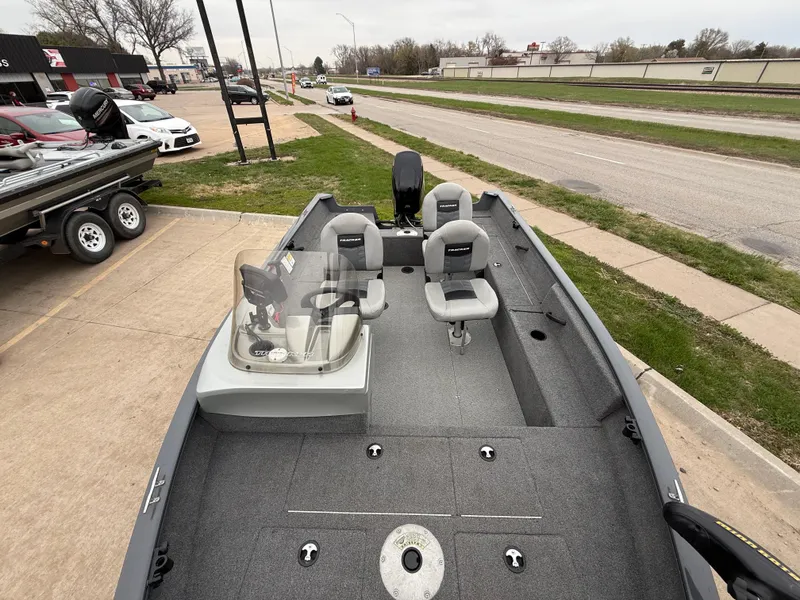 Slide: The Image of 2017 Tracker Pro Guide V-16 SC fishing boat with seating and console, parked on pavement. - 8