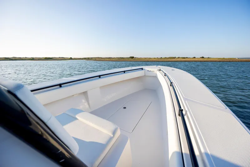 Slide: The Image of 2014 SeaHunter 32 Tournament boat on calm water, clear sky, scenic view. - 10