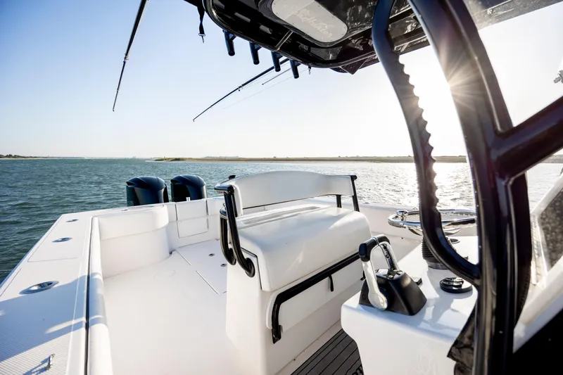 Slide: The Image of 2014 SeaHunter 32 Tournament boat on water, featuring spacious deck and dual engines. - 14