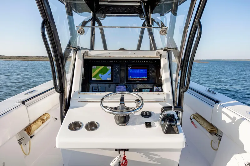 Slide: The Image of 2014 SeaHunter 32 Tournament boat dashboard with navigation screens on open water. - 16