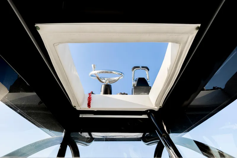 Slide: The Image of 2014 SeaHunter 32 Tournament boat helm view through open hatch. - 17