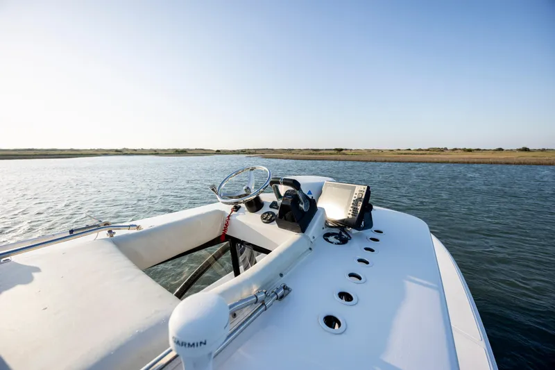 Slide: The Image of 2014 SeaHunter 32 Tournament boat on calm water, featuring a sleek helm and clear sky. - 18