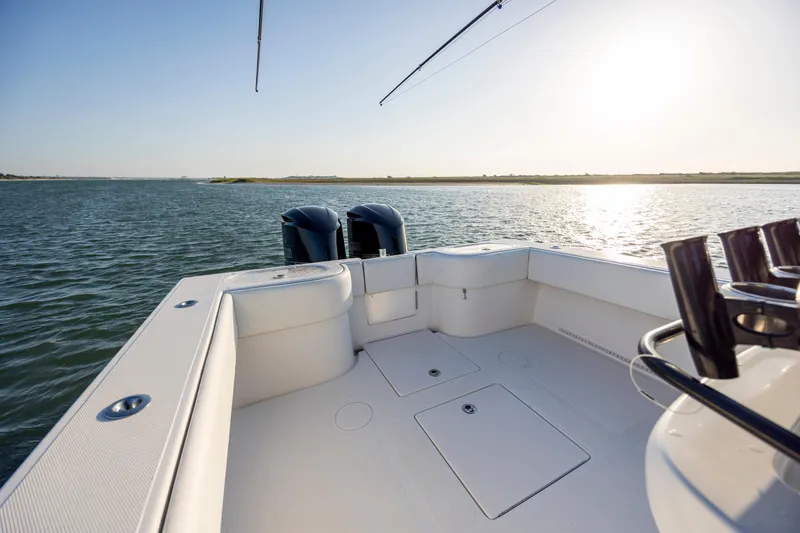 Slide: The Image of 2014 SeaHunter 32 Tournament boat deck with dual engines on calm water. - 20