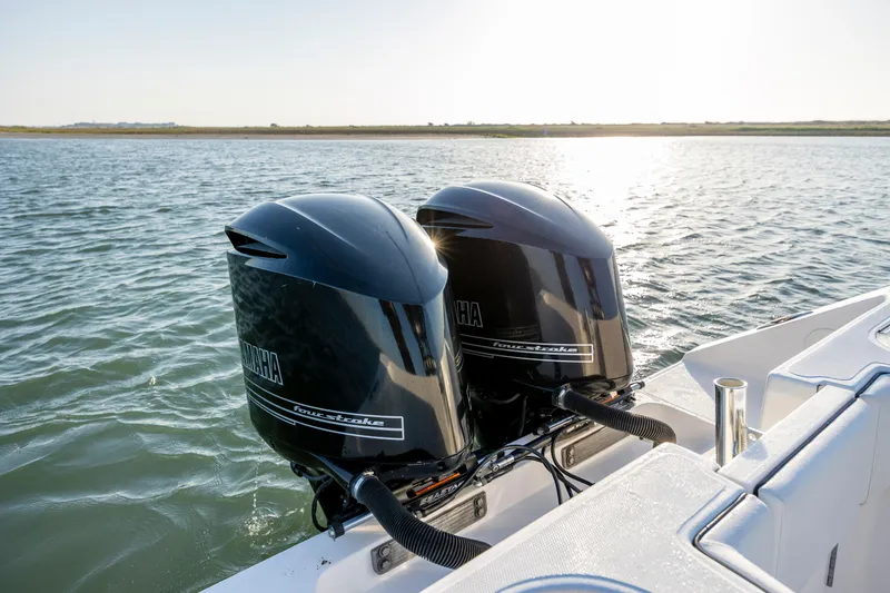 Slide: The Image of Twin Yamaha outboard engines on a 2014 SeaHunter 32 Tournament boat in open water. - 22
