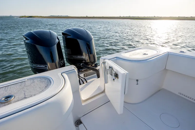 Slide: The Image of 2014 SeaHunter 32 Tournament boat with twin Yamaha outboard engines on calm water. - 23