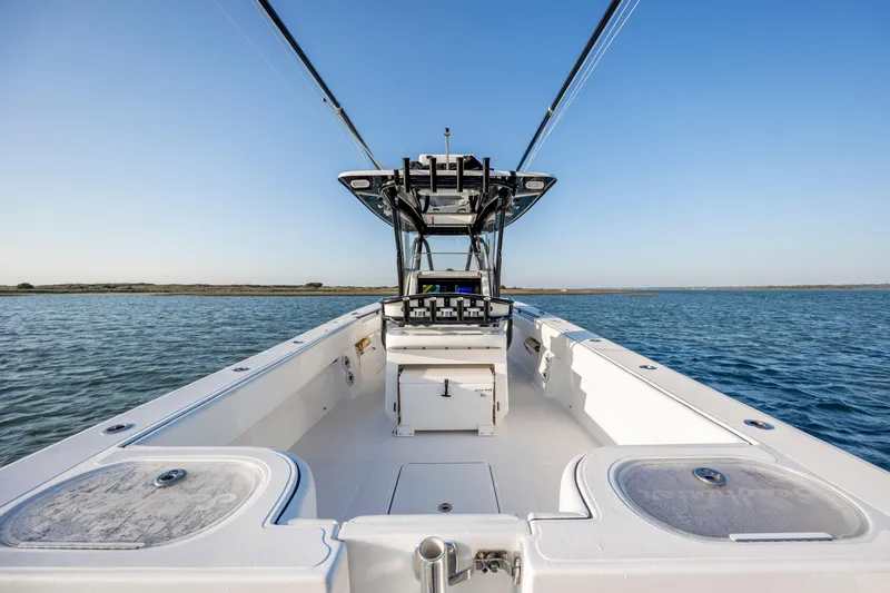 Slide: The Image of 2014 SeaHunter 32 Tournament boat on open water, clear sky, spacious deck. - 25