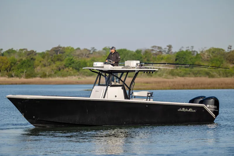 Slide: The Image of 2014 SeaHunter 32 Tournament boat on calm water with fishing gear. - 3