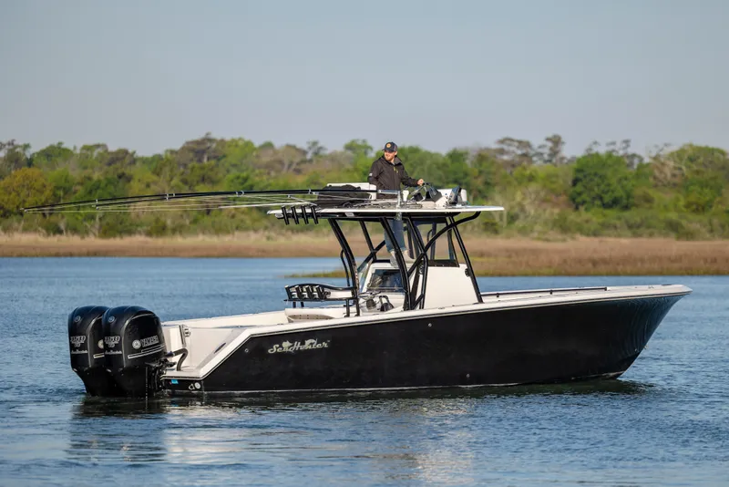 Slide: The Image of 2014 SeaHunter 32 Tournament boat on calm water with dual Yamaha engines. - 7